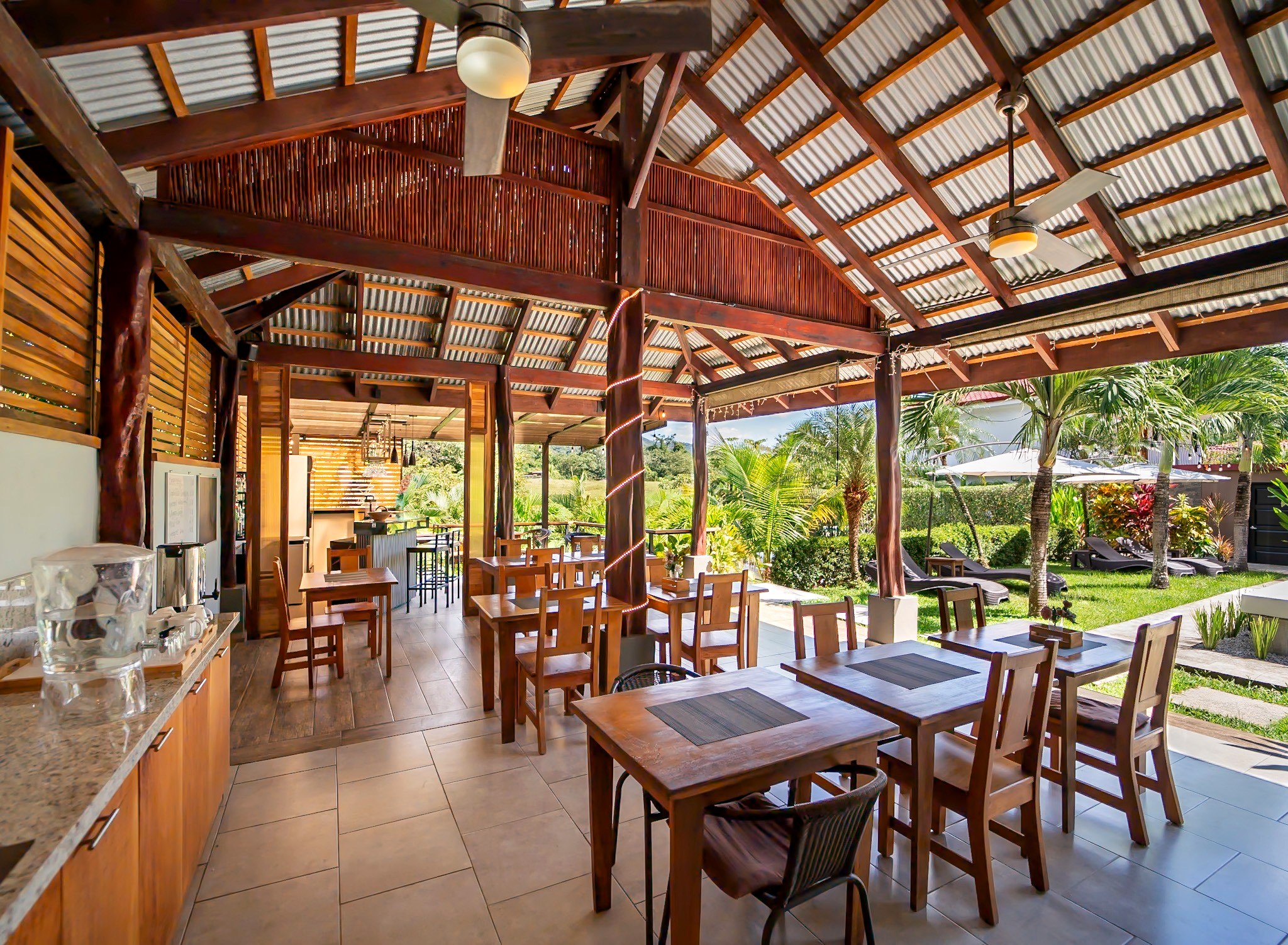 Open-air breakfast and bar area at Casa Buenavista Hotel